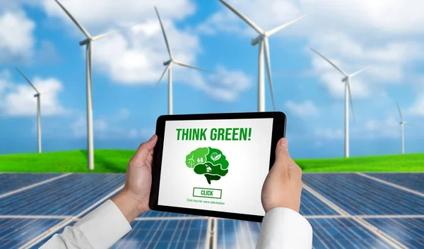 Green business transformation for environment saving and ESG business concept. Businessman using tablet to set corporate goal toward environmental friendly management and alternative clean energy use.