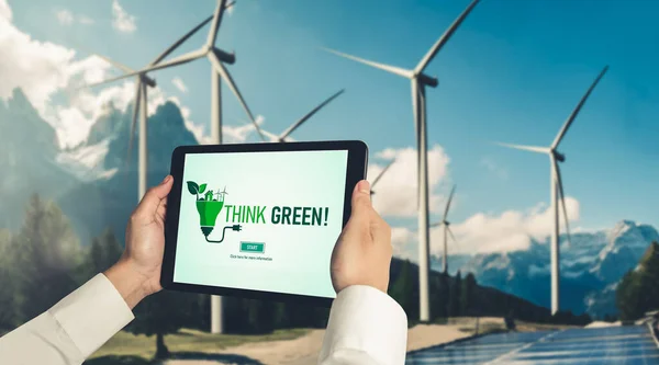 Green business transformation for environment saving and ESG business concept. Businessman using tablet to set corporate goal toward environmental friendly management and alternative clean energy use.