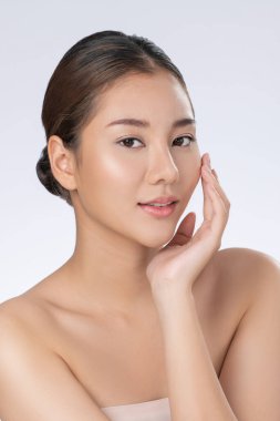 Portrait of gorgeous young girl posing beauty gesture with healthy clear skin and soft makeup. Cosmetology and beauty concept.