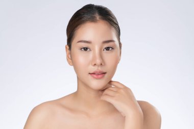 Portrait of gorgeous young girl posing beauty gesture with healthy clear skin and soft makeup. Cosmetology and beauty concept.