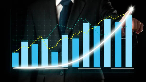 Businessman draw finance allusive graph chart showing business profit growth increasing to future target . Excellent financial status of corporate business rise up . Finance and money technology .