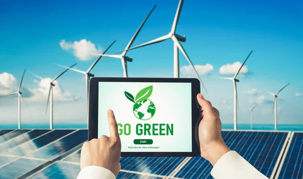 Green business transformation for environment saving and ESG business concept. Businessman using tablet to set corporate goal toward environmental friendly management and alternative clean energy use.