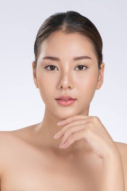 Portrait of gorgeous young girl posing beauty gesture with healthy clear skin and soft makeup. Cosmetology and beauty concept.