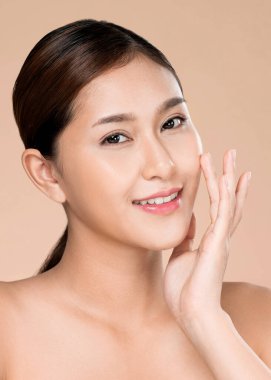 Closeup ardent young woman with healthy clear skin and soft makeup looking at camera and posing beauty gesture. Cosmetology skincare and beauty concept.