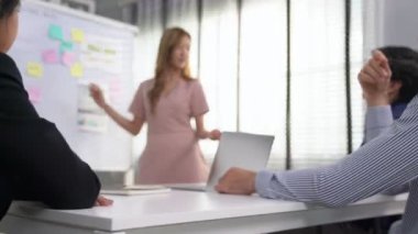 Competent office workers from various nationalities are debating, discussing and brainstorming in the meeting room. A group of employees is collaborating to achieve their business objectives.