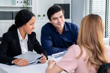 A young female asian candidate tries to impress her interviewer by being competent. International company, multicultural environment in workplace.