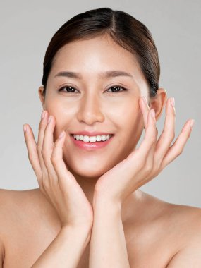 Closeup ardent young woman with healthy clear skin and soft makeup looking at camera and posing beauty gesture. Cosmetology skincare and beauty concept.