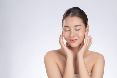 Portrait of gorgeous young girl posing beauty gesture with healthy clear skin and soft makeup. Cosmetology and beauty concept.