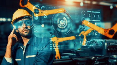 Engineer use cybernated robotic software to control industry robot arm in factory . Automation manufacturing process controlled by specialist using IOT software connected to internet network .