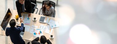 Group business people handshake at meeting table in widen view in office together with confident shot from top view . Young businessman and businesswoman workers express agreement of investment deal.