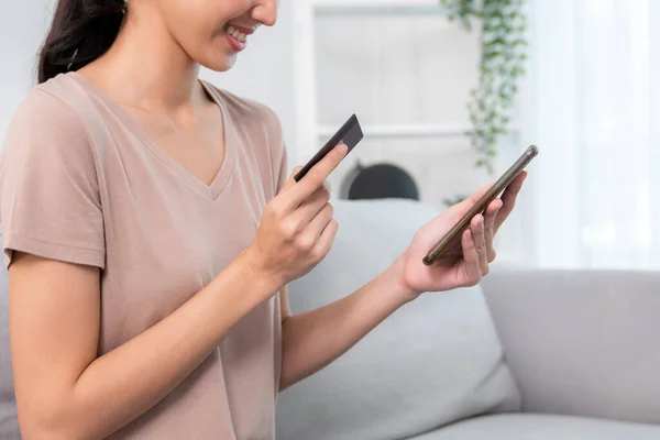 Contented Young Woman Eagerly Makes Online Purchase Using Her Smartphone — Stockfoto