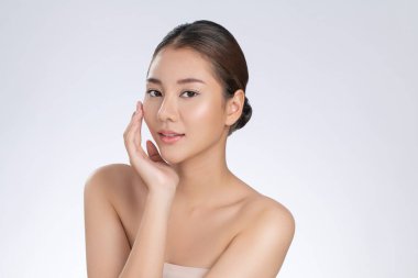 Portrait of gorgeous young girl posing beauty gesture with healthy clear skin and soft makeup. Cosmetology and beauty concept.