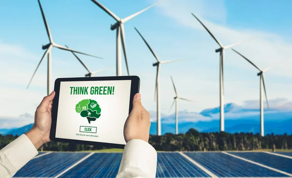 Green business transformation for environment saving and ESG business concept. Businessman using tablet to set corporate goal toward environmental friendly management and alternative clean energy use.