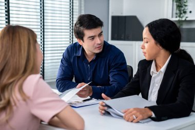 A young female asian candidate tries to impress her interviewer by being competent. International company, multicultural environment in workplace.