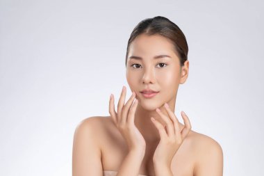 Portrait of gorgeous young girl posing beauty gesture with healthy clear skin and soft makeup. Cosmetology and beauty concept.