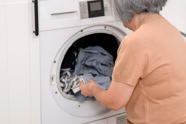Contented Senior Housewife Doing Laundry Laundry Room Clothes Washing Machine — Stok fotoğraf