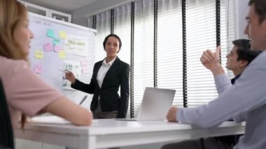 Competent office workers from various nationalities are debating, discussing and brainstorming in the meeting room. A group of employees is collaborating to achieve their business objectives.