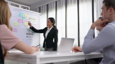 Competent office workers from various nationalities are debating, discussing and brainstorming in the meeting room. A group of employees is collaborating to achieve their business objectives.