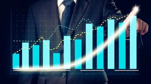 Businessman draw finance allusive graph chart showing business profit growth increasing to future target . Excellent financial status of corporate business rise up . Finance and money technology .