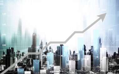 As background for a financial or business concept, digital screen and financial graphs overlap on a picture of modernistic cityscape, skyscrabbers.