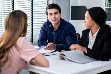 A young female asian candidate tries to impress her interviewer by being competent. International company, multicultural environment in workplace.