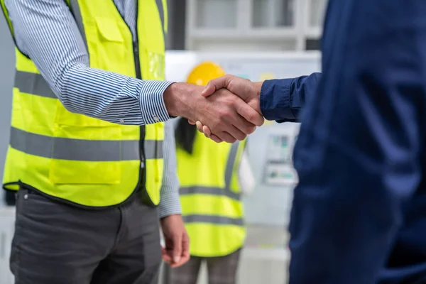 After concluding the meeting, competent investor shakes hands with engineer. Concept of the agreement between engineers and investors.