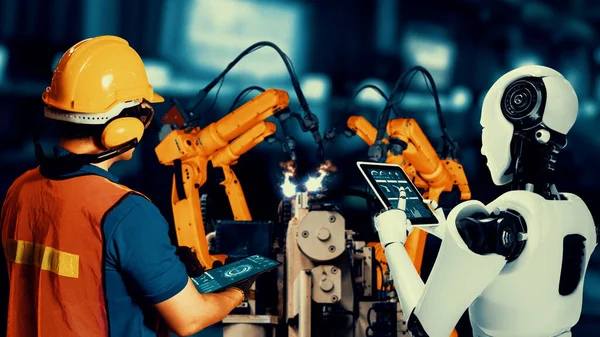 Cybernated industry robot and human worker working together in future factory . Concept of artificial intelligence for industrial revolution and automation manufacturing process .