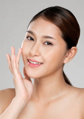 Closeup ardent young woman with healthy clear skin and soft makeup looking at camera and posing beauty gesture. Cosmetology skincare and beauty concept.