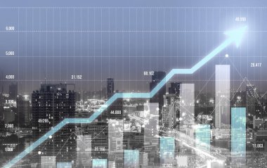 As background for a financial or business concept, digital screen and financial graphs overlap on a picture of modernistic cityscape, skyscrabbers.