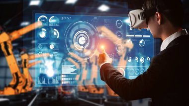 Engineer use cybernated robotic software to control industry robot arm in factory . Automation manufacturing process controlled by specialist using IOT software connected to internet network .