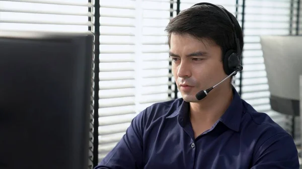 Young Competent Asian Male Call Center Agent Working His Computer — ストック写真