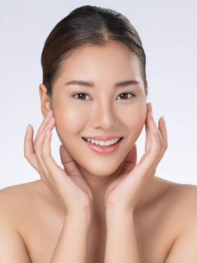 Portrait of gorgeous young girl posing beauty gesture with healthy clear skin and soft makeup. Cosmetology and beauty concept.