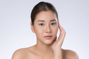 Portrait of gorgeous young girl posing beauty gesture with healthy clear skin and soft makeup. Cosmetology and beauty concept.