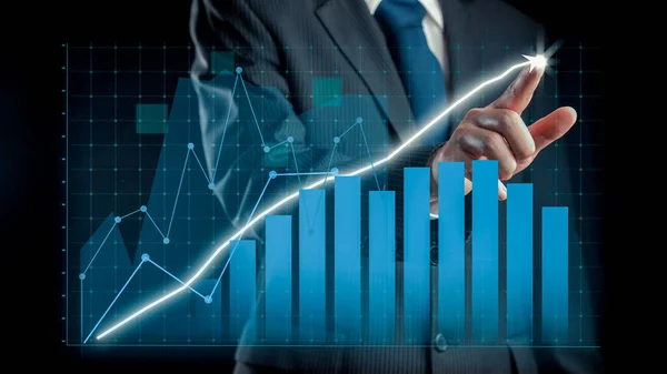 Businessman draw finance allusive graph chart showing business profit growth increasing to future target . Excellent financial status of corporate business rise up . Finance and money technology .