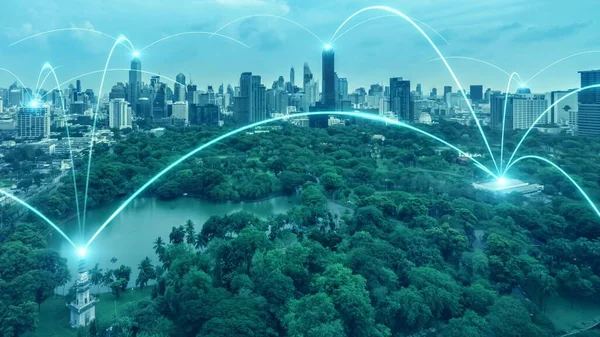 Smart digital city with connection network reciprocity over the cityscape . Concept of future smart wireless digital city and social media networking systems that connects people within the city .