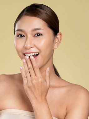 Closeup ardent young woman with healthy clear skin and soft makeup looking at camera and posing beauty gesture. Cosmetology skincare and beauty concept.