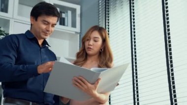 Concept of experienced and competent coworker, employer, supervisor giving advice to a young asian female office worker. Teamwork between coworkers, leadership company.