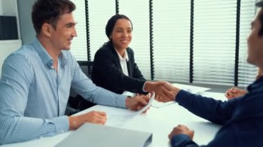 Commercial contract signed by competent people of various ethnicities and shake hands. Trade agreements, two-party business transactions.