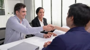 Commercial contract signed by competent people of various ethnicities and shake hands. Trade agreements, two-party business transactions.