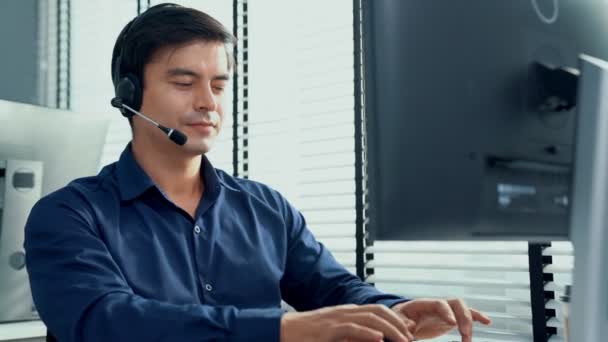 Young Competent Asian Male Call Center Agent Working His Computer — Vídeos de Stock