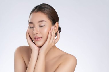 Portrait of gorgeous young girl posing beauty gesture with healthy clear skin and soft makeup. Cosmetology and beauty concept.