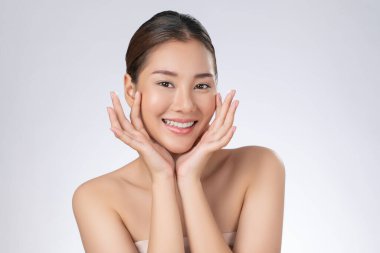 Portrait of gorgeous young girl posing beauty gesture with healthy clear skin and soft makeup. Cosmetology and beauty concept.