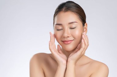 Portrait of gorgeous young girl posing beauty gesture with healthy clear skin and soft makeup. Cosmetology and beauty concept.