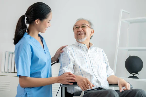 Happy Positive Asian Nurse Giving Support Touching Contented Senior Man — Foto Stock