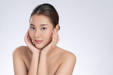 Portrait of gorgeous young girl posing beauty gesture with healthy clear skin and soft makeup. Cosmetology and beauty concept.