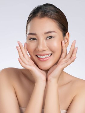 Portrait of gorgeous young girl posing beauty gesture with healthy clear skin and soft makeup. Cosmetology and beauty concept.