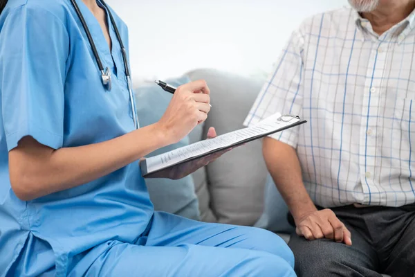 Young Female Doctor Inquires Personal Information Contented Senior Home Medical — Foto Stock