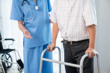 Physiotherapist assists contented senior man on folding walker. Recuperation for elderly, seniors care, nursing home.