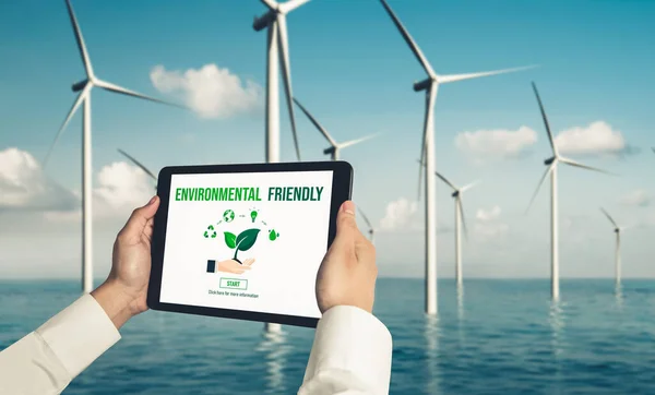 Green business transformation for environment saving and ESG business concept. Businessman using tablet to set corporate goal toward environmental friendly management and alternative clean energy use.