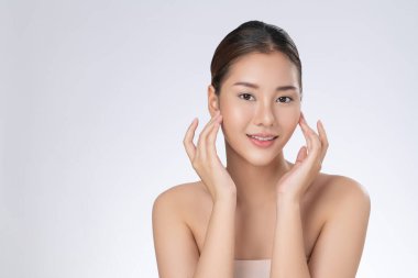 Portrait of gorgeous young girl posing beauty gesture with healthy clear skin and soft makeup. Cosmetology and beauty concept.
